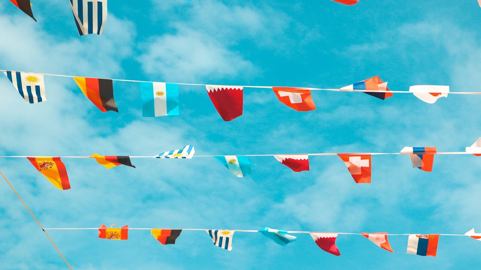 a bunch of flags that are hanging in the air