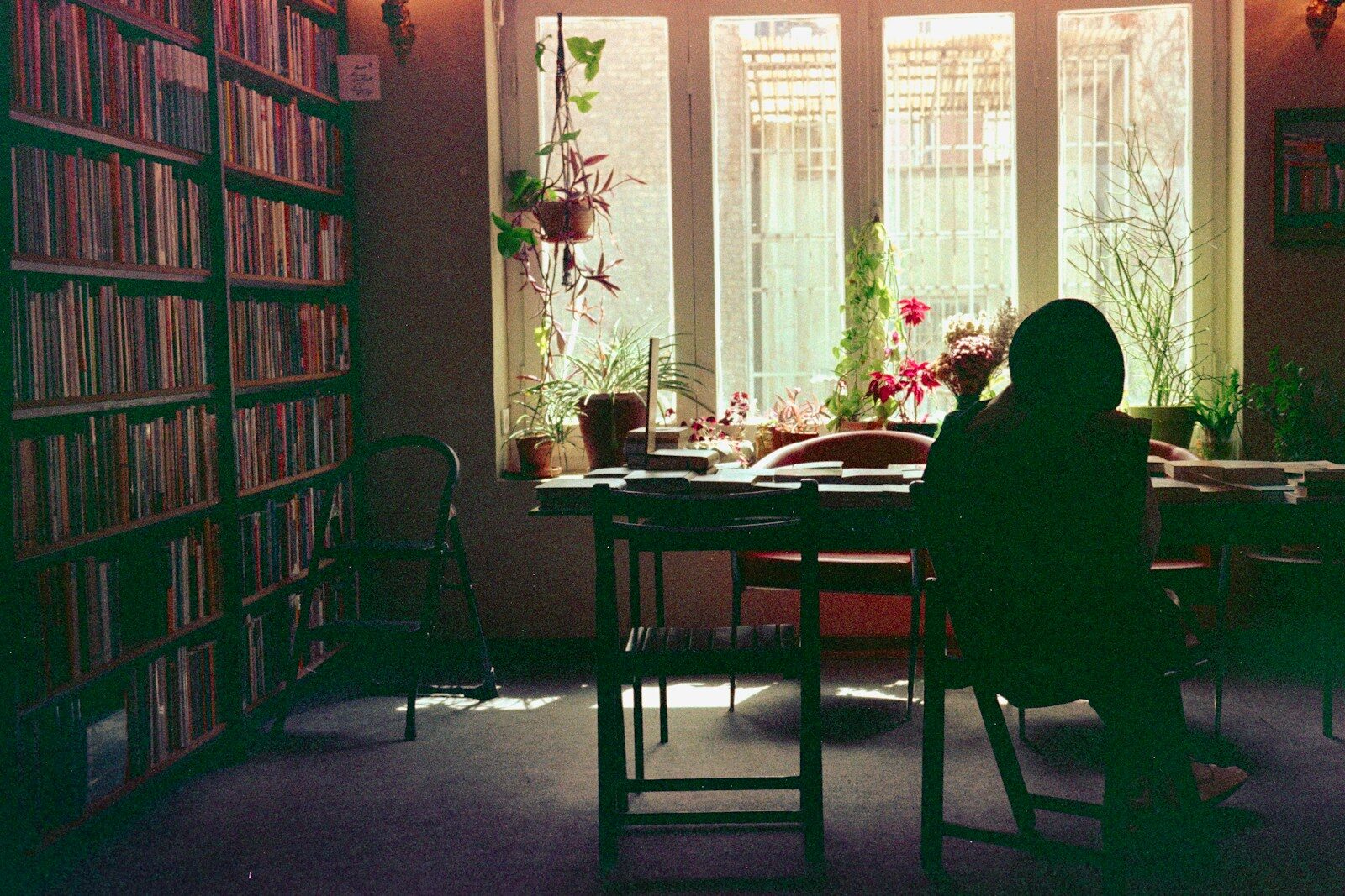A person sitting at a table in a library